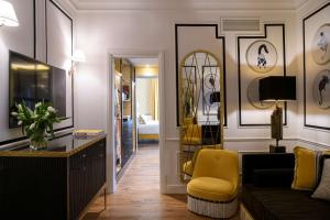 a living room with a couch and a yellow chair at IL Tornabuoni The Unbound Collection by Hyatt in Florence