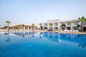 a large swimming pool in front of a hotel at Radisson Blu Resort, Saidia Garden in Saidia 