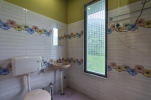 La salle de bains est pourvue de toilettes et d'un lavabo. dans l'établissement Zostel Homes Harabhag, Jogindernagar, à Bir