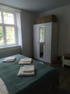a bedroom with a bed with two towels on it at PISQOR Apartment - self check-in in Bratislava