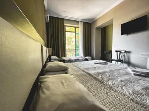 Voodi või voodid majutusasutuse Discovery Hotel toas