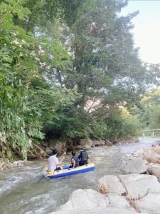 three people on a raft in a river at Sisilli Pension in Pyeongchang