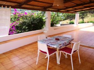 a table and chairs on a patio with flowers at Da Riccardo in Malfa