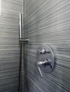 a shower stall with a shower head on a wall at Hotel Roma 62 in Palermo