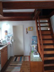 a kitchen with a staircase leading up to a kitchen at Apartmani Planinska kuća, Jagodnja in Krupanj