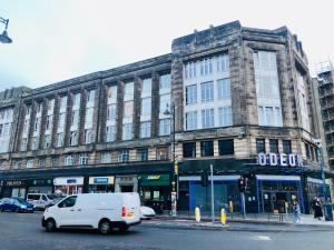 a white van driving down a street in front of a building at Charming 1-Bed City Centre Apartment in Edinburgh in Edinburgh