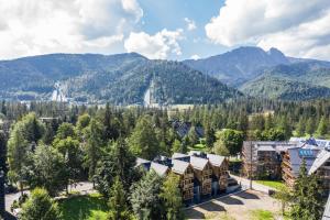 an aerial view of a resort with mountains in the background at TatryTop Apartamenty Sabała in Zakopane