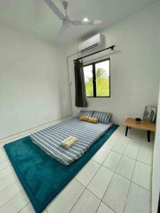 a bedroom with a mattress on the floor with a window at Inderaloka Villa 23A Free Parking in Shah Alam