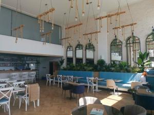 a restaurant with tables and chairs in a building at Двухкомнатные апартаменты в жилом комплексе Caesar Beach D1 Flat15 in Boğaz