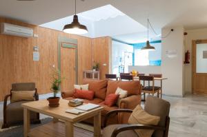 a living room with a couch and a table at The Nomad Hostel&Pension in Seville