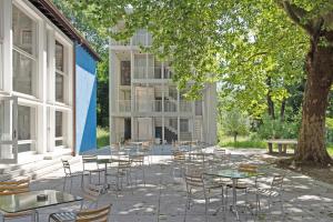 a group of tables and chairs in front of a building at Bern Youth Hostel in Bern