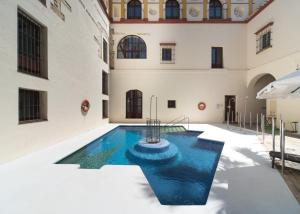 an indoor pool in the middle of a building at Hotel Palacio Marqu&eacute;s de Ariz&oacute;n in Sanl&uacute;car de Barrameda