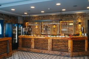 a bar in a restaurant with a stone wall at Akkan Hotel in Bodrum City