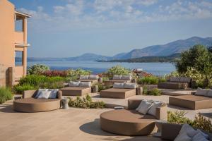 a patio with couches and a view of the water at Thalassa Boutique Hotel - Adults Only in Lassi