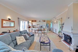 a living room with a couch and a fireplace at Casa dos Sonhos by Portucasa in São Brás de Alportel