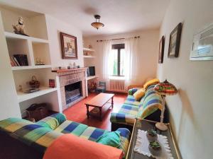 a living room with two couches and a fireplace at Casa Juanito in Riópar