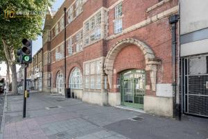 a traffic light in front of a brick building at Entire 2 Bed Flat Plaistow,Canning town Prime Location in London in London