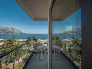 a balcony with two chairs and a view of the ocean at Hotel Montenegro in Budva