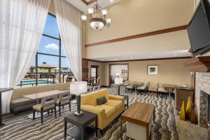 a living room with a couch and chairs and a fireplace at Staybridge Suites Oklahoma City-Quail Springs by IHG in Oklahoma City