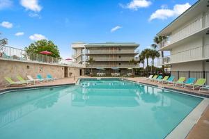 a large swimming pool with chairs and a building at Royal 1 in Kissimmee
