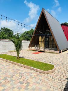 a small house with a roof on a brick patio at A-Frame Kobuleti in K'obulet'i