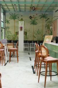 um quarto com cadeiras e uma parede com palmeiras em Hotel Brahma Horizon em Pushkar