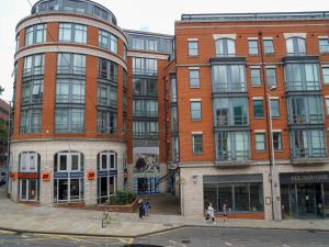 a group of tall buildings on a city street at Pass the Keys Charming Central Apartment Steps from Nottingham's Best in Nottingham