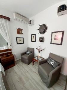 a living room with two chairs and a couch at City House Apartments in Tivat