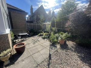 a garden with potted plants on a patio at Beautiful Peebles Bungalow in Peebles