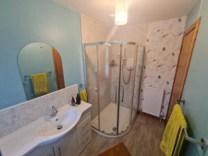 a bathroom with a shower and a sink at Beautiful Peebles Bungalow in Peebles