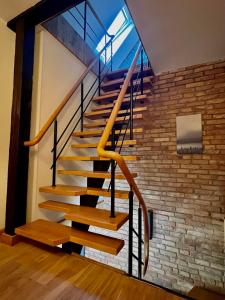 a staircase in a house with a brick wall at Vāgnera parks in Tukums