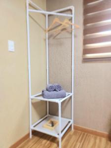 a white shelf with towels on it in a room at TreehouseUnseo GuestHouse in Incheon +58 photos