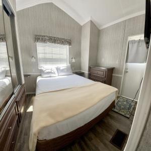 a bedroom with a large bed and a window at Ocean Grove RV Resort St Augustine in Saint Augustine