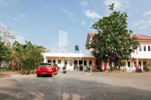 a red car parked in front of a building at KORPRI Live House RedPartner 