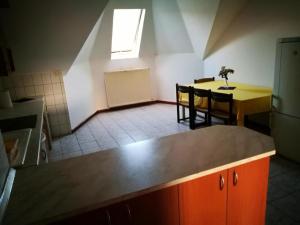 a kitchen and dining room with a table and chairs at Peregrino Vendégház in Budaörs