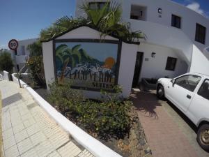 a white car parked in front of a building at Lago Verde Suite 25 in Puerto del Carmen