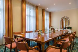 فندق نوفوم كرونبرينز برلين في برلين: قاعة المؤتمرات مع طاولة وكراسي طويلة