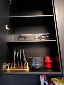 a kitchen cabinet with utensils on a shelf at Edge Central Pattaya Condo หรูใจกลางเมืองพัทยา in Pattaya Central