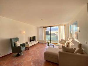 a living room with a couch and a television at Callantsoger Staete A206 in Callantsoog