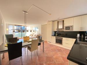 a kitchen and dining room with a table and chairs at Callantsoger Staete A206 in Callantsoog