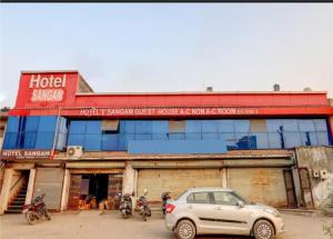 a hotel with motorcycles parked in front of a building at Hotel Sangam in Ahmedabad