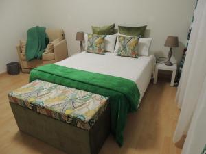 a bedroom with a large bed with a green blanket at Casa Belón in San Román
