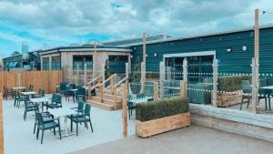 a restaurant with tables and chairs in front of a building at willerby lamberhurst in Kent