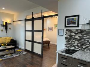 a kitchen and a living room with a counter top at Uber Close to Ohio City, Cleveland (Lower) in Cleveland