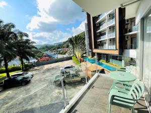 a balcony with a view of a parking lot at Chic Condo in Karon by Lofty in Karon Beach