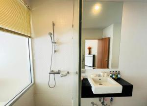 a bathroom with a sink and a shower at Chic Condo in Karon by Lofty in Karon Beach +10 photos