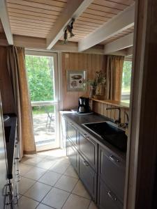 a kitchen with a sink and a counter with a window at Haus Sandra in Baabe