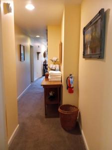 a hallway with a table and a basket in a room at Laughing Heart Lodge in Hot Springs