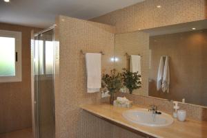 a bathroom with a sink and a mirror at Villa Teresa in Colonia Sant Jordi +14 photos