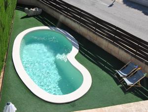 an overhead view of a swimming pool with two chairs at Villa Teresa in Colonia Sant Jordi